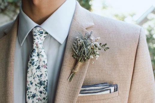 Beige suite with flower tie and blue shirt