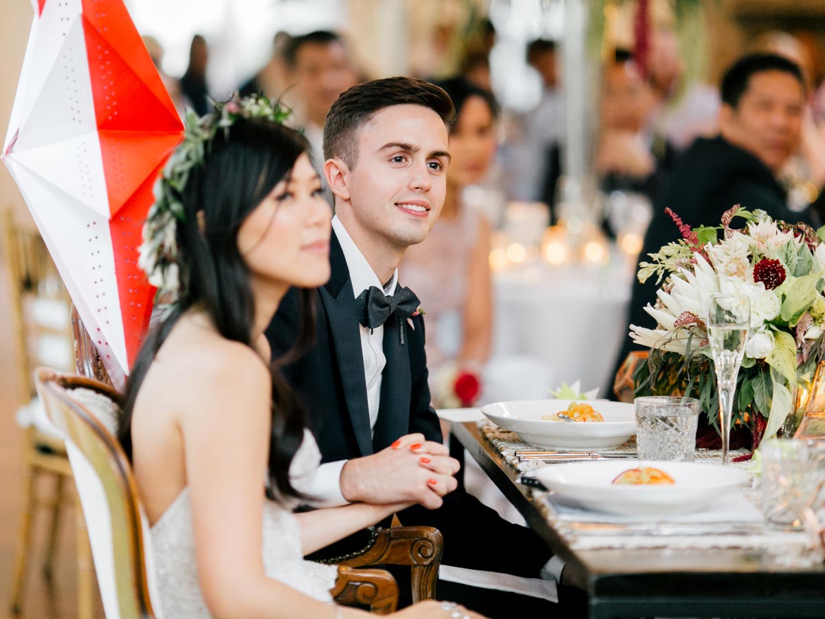 Susan and Tom sitting eating dinner at their wedding