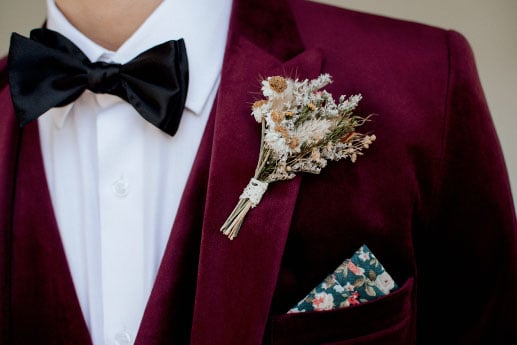 Maroon suit with white shirt and black bow tie