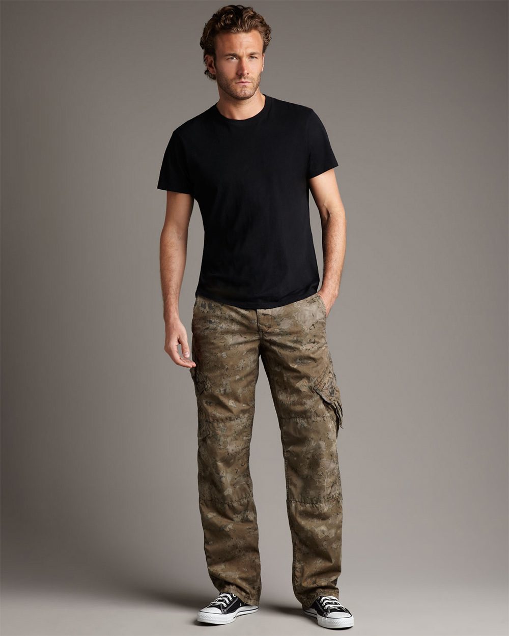 man wearing camo pants and a black shirt