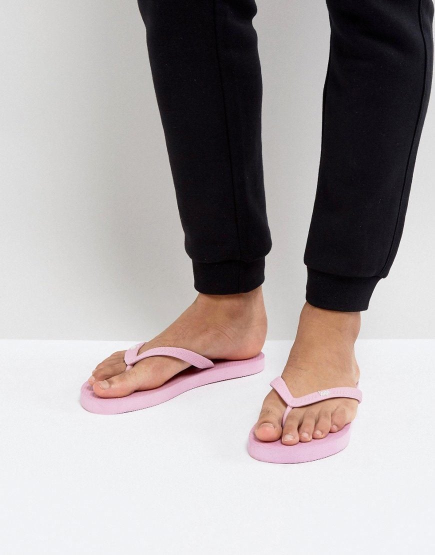 Man wearing pink flip flops