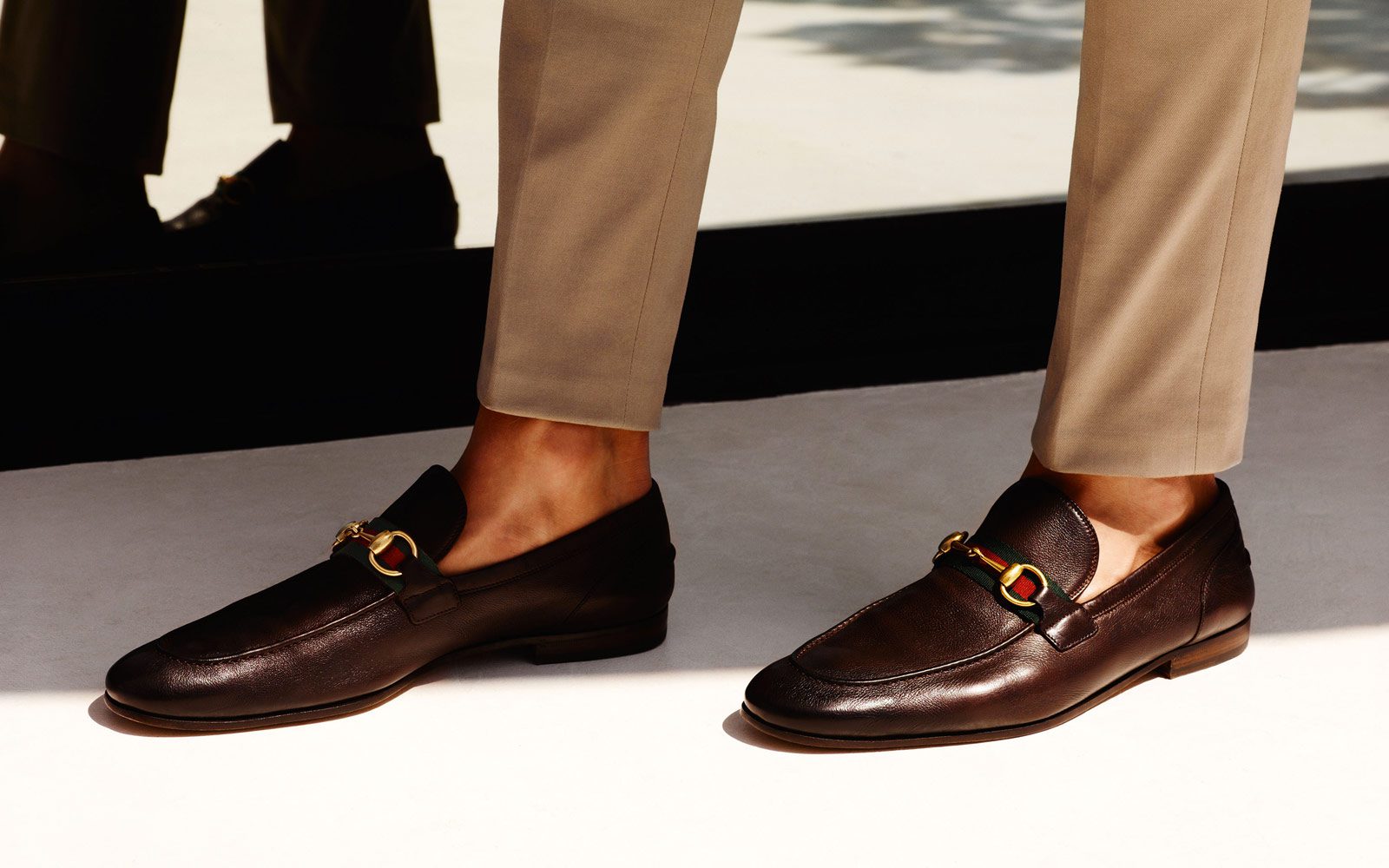 Man wearing brown Gucci Loafers