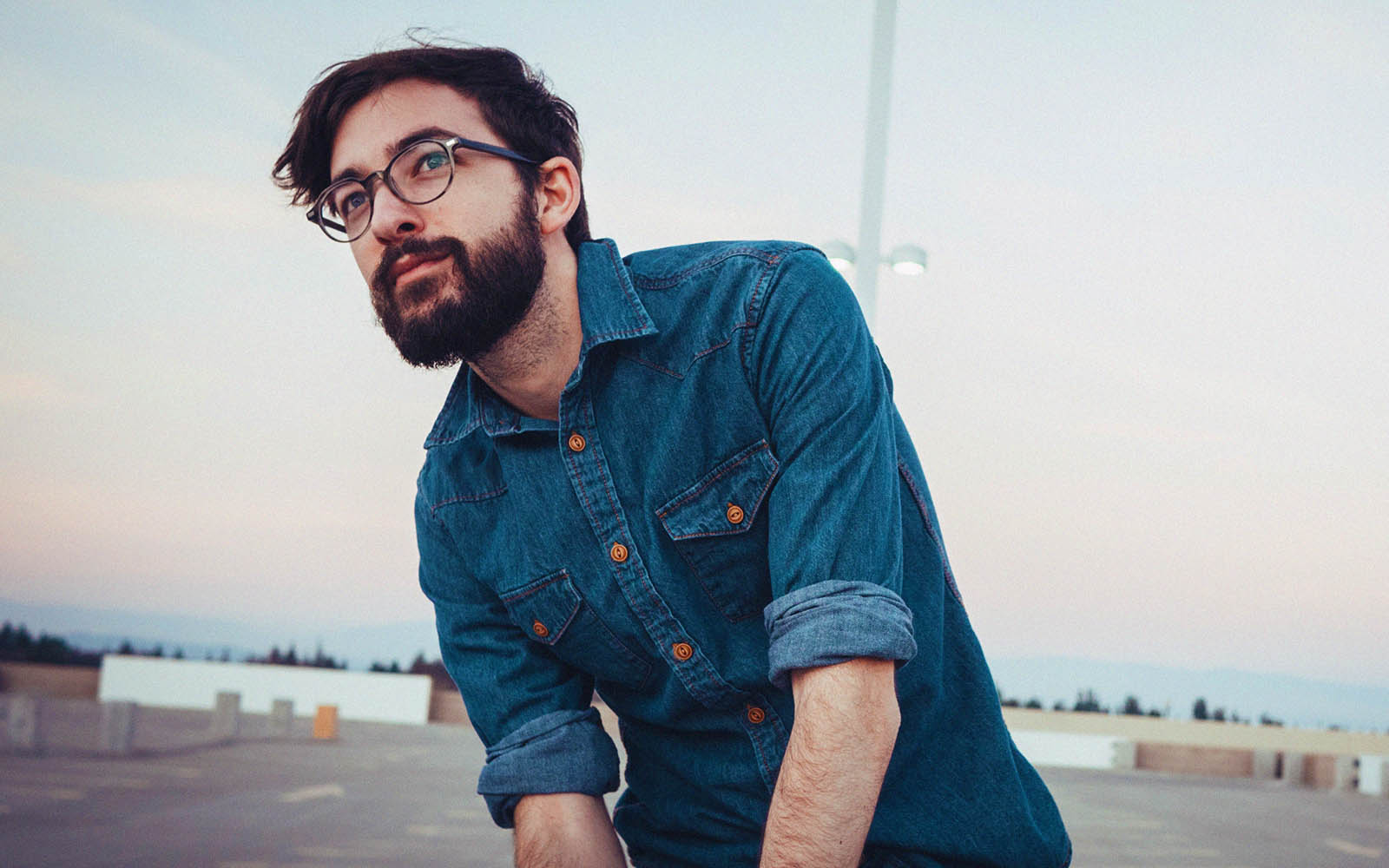 Bearded man wearing glasses and blue flannel