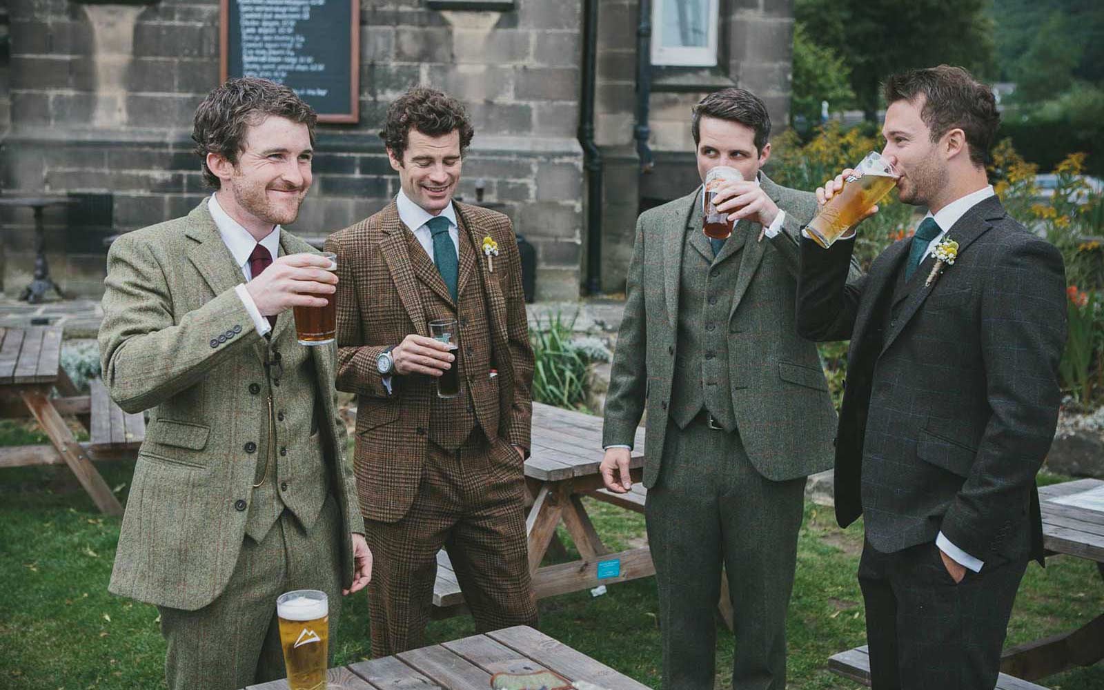 Men in tweed suits drinking beer