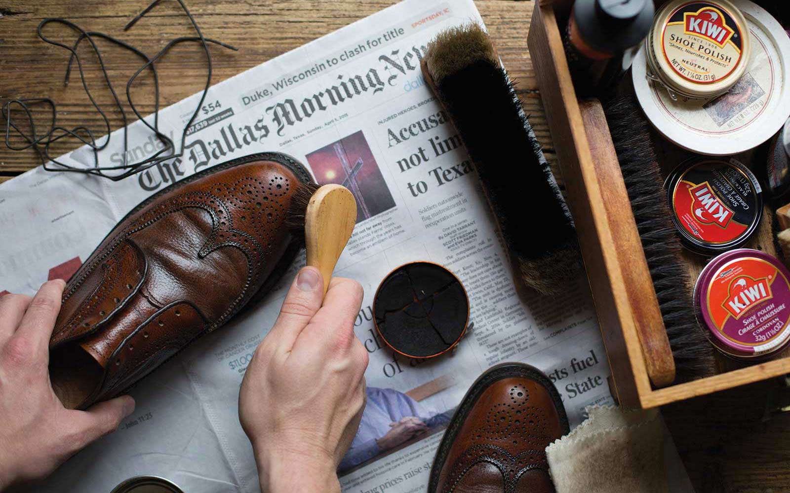 man cleaning dress shoes