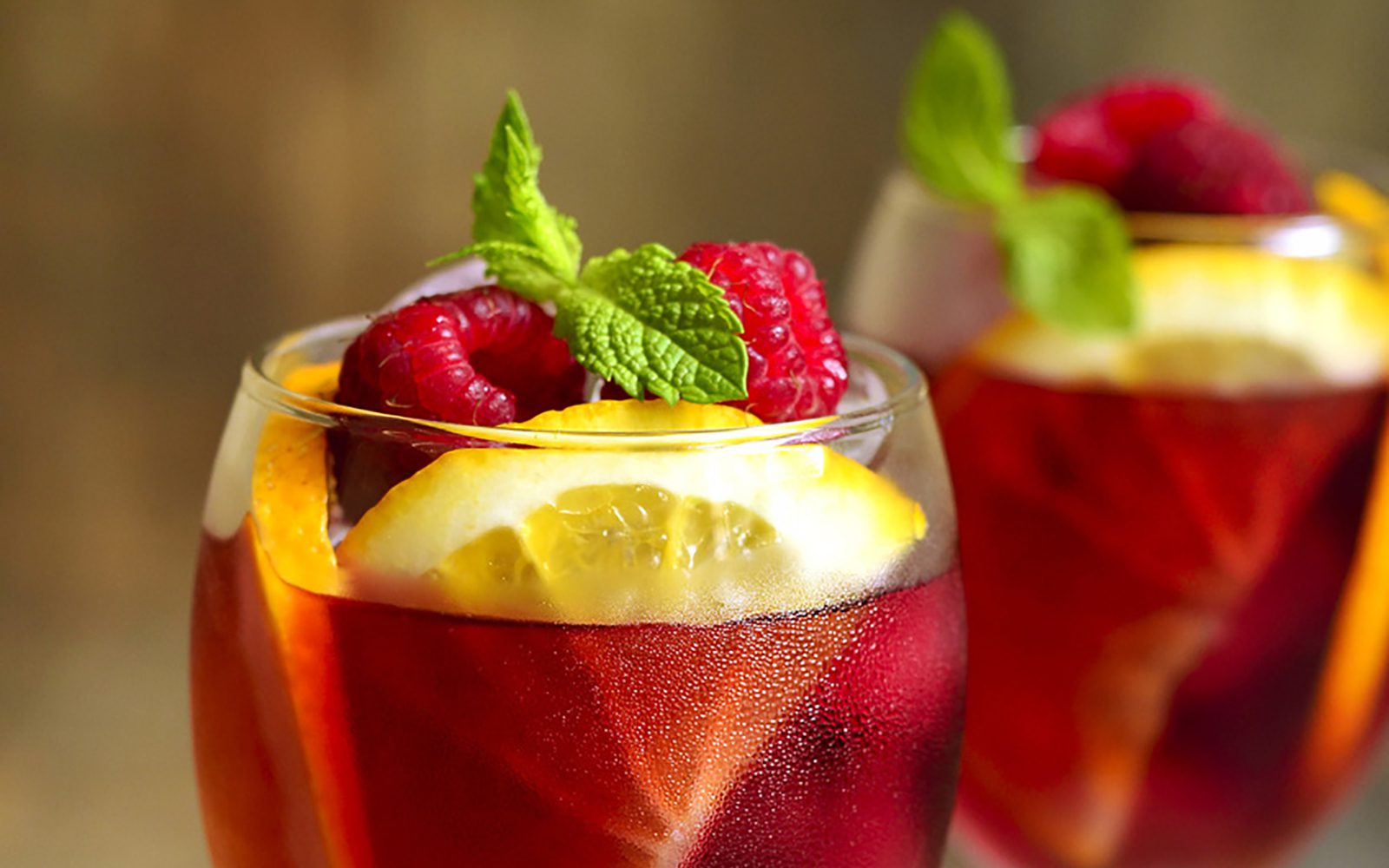 Drink garnished with mint, rasberries and lemon