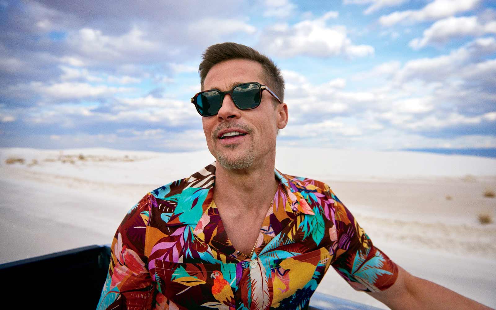 man wearing colorful print shirt in the desert
