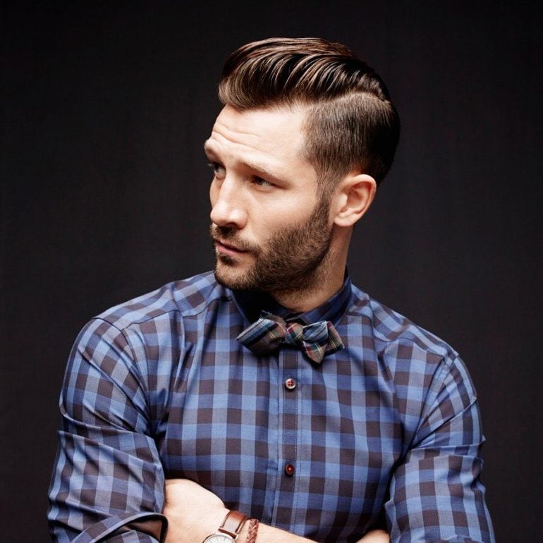 bearded man with checkered shirt and bow tie