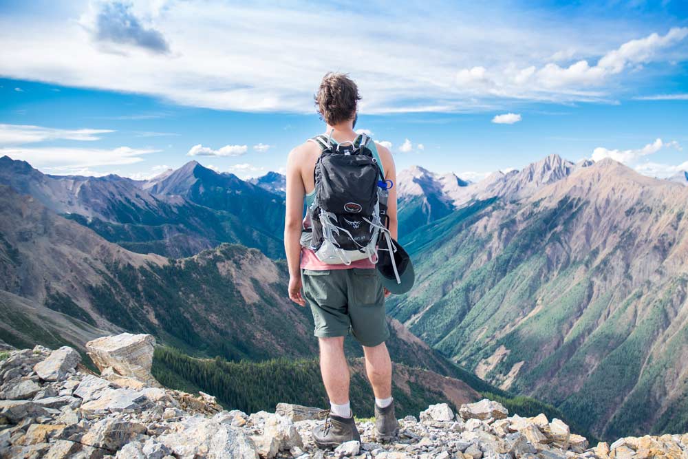 man-hiking-mountain-wearing-backpack