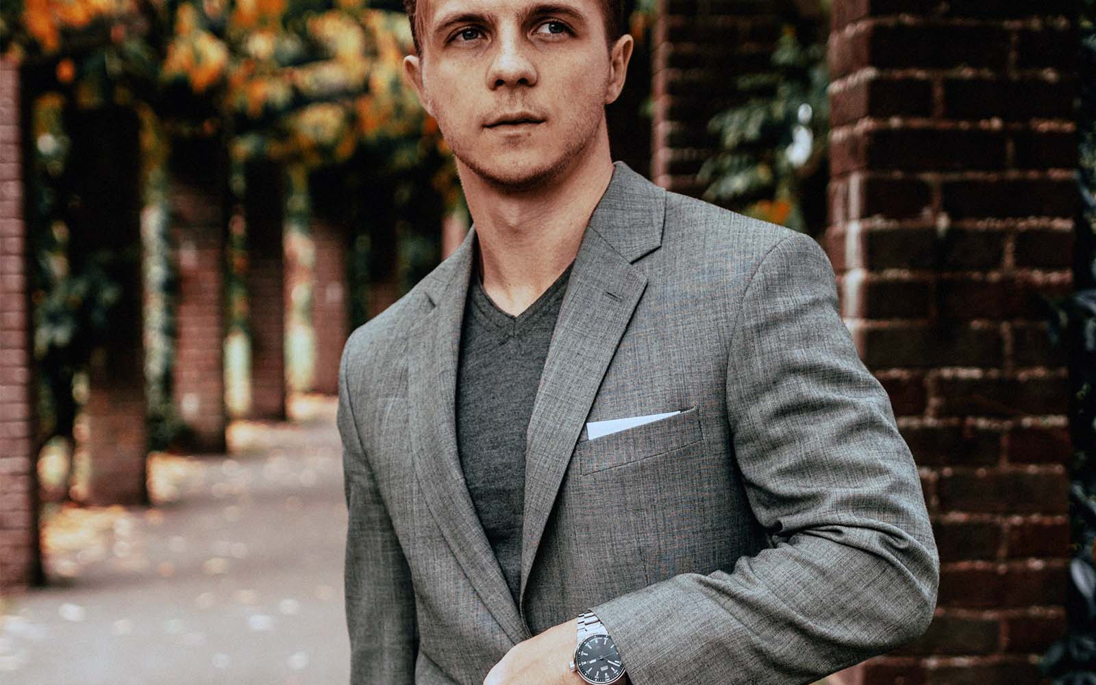 Male model wearing grey suit with a grey shirt