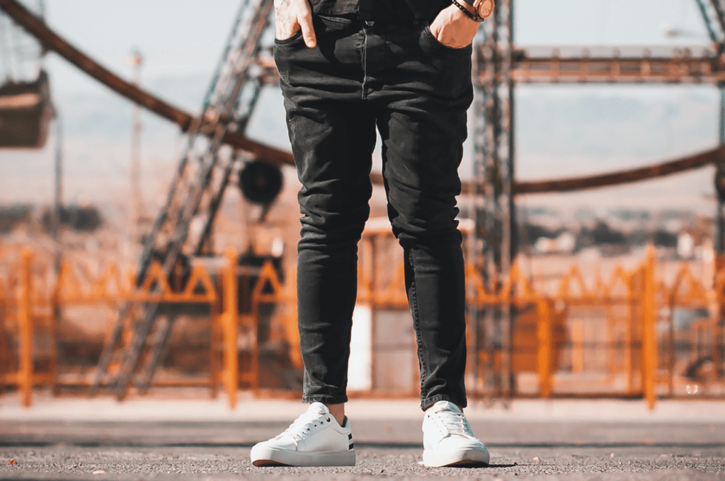 A guy wearing black jeans with a short inseam